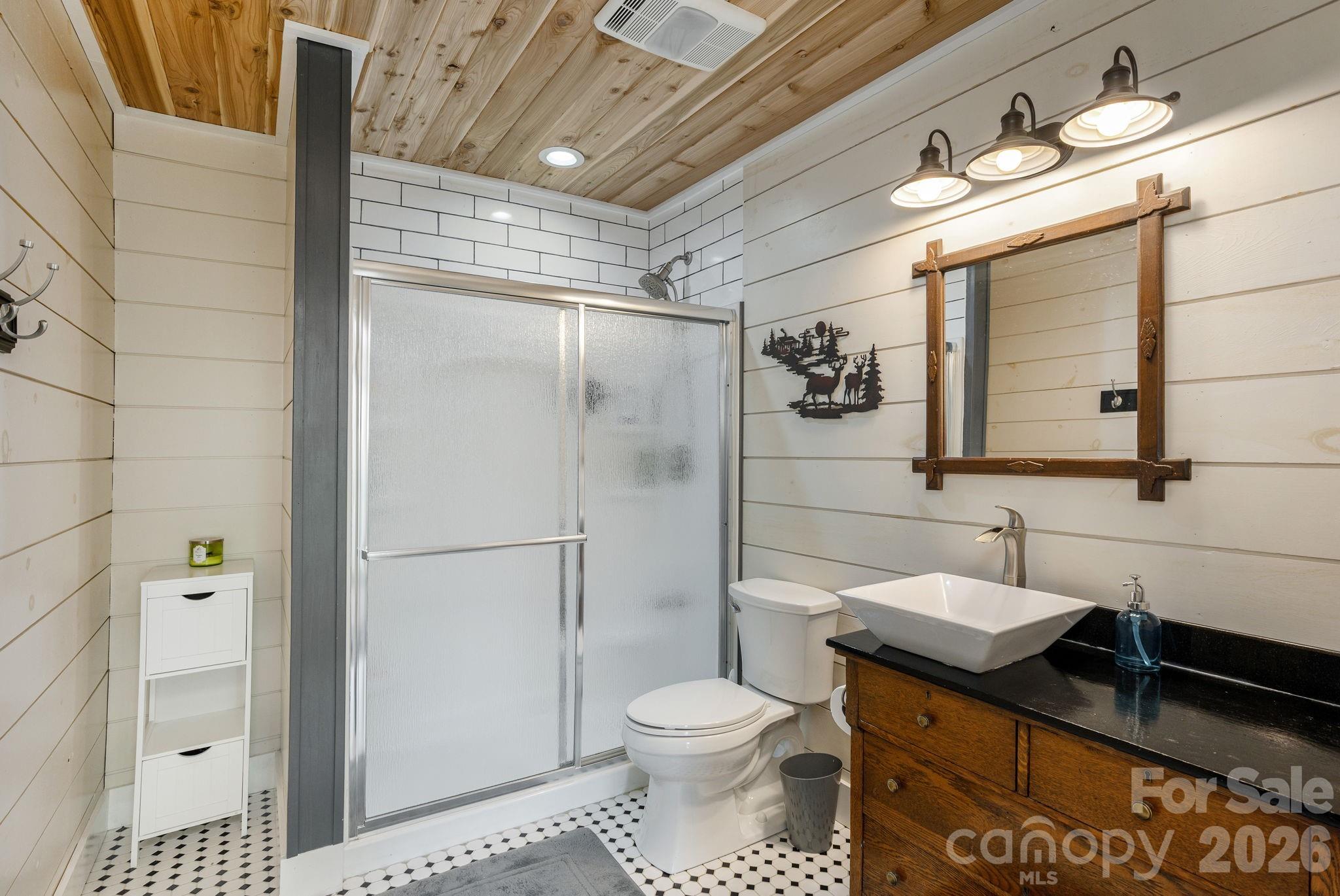 149 Hiwassee Road Lake Toxaway, NC 28747 - Photo 32 of 48 a bathroom with a granite countertop sink toilet and shower