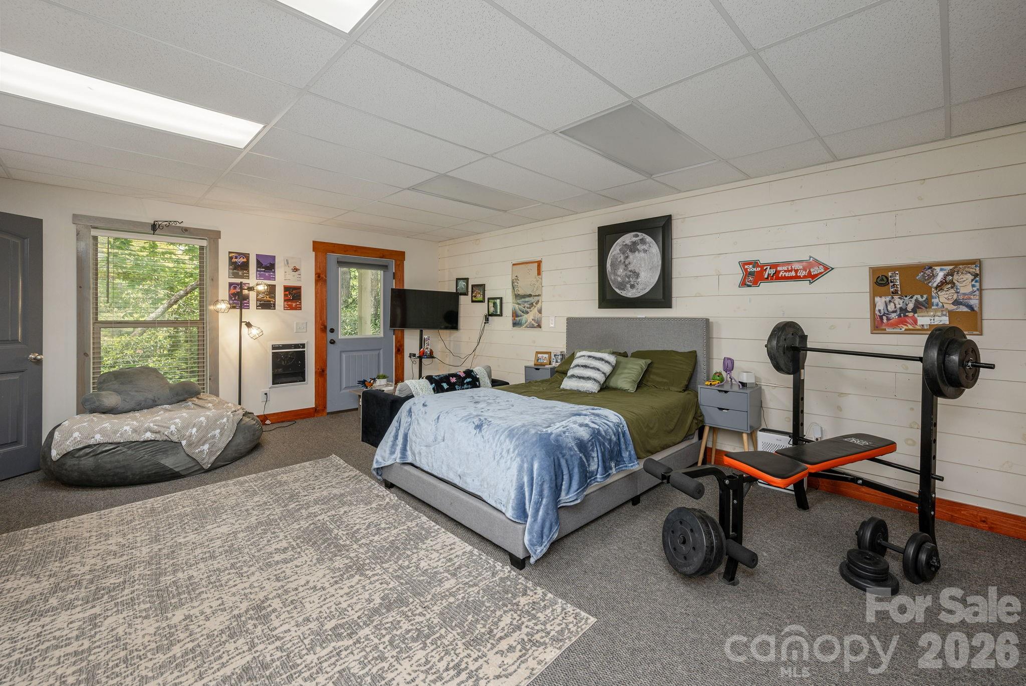 149 Hiwassee Road Lake Toxaway, NC 28747 - Photo 33 of 48 a spacious bedroom with a bed a table chair and a window