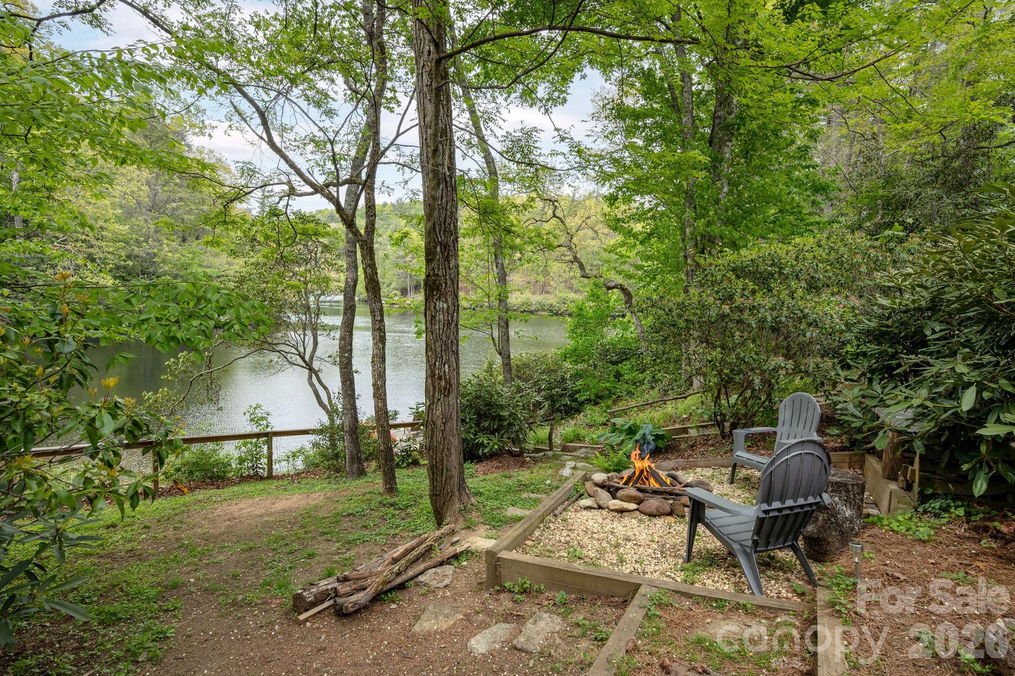 149 Hiwassee Road Lake Toxaway, NC 28747 - Photo 39 of 48 a backyard of a house with table and chairs