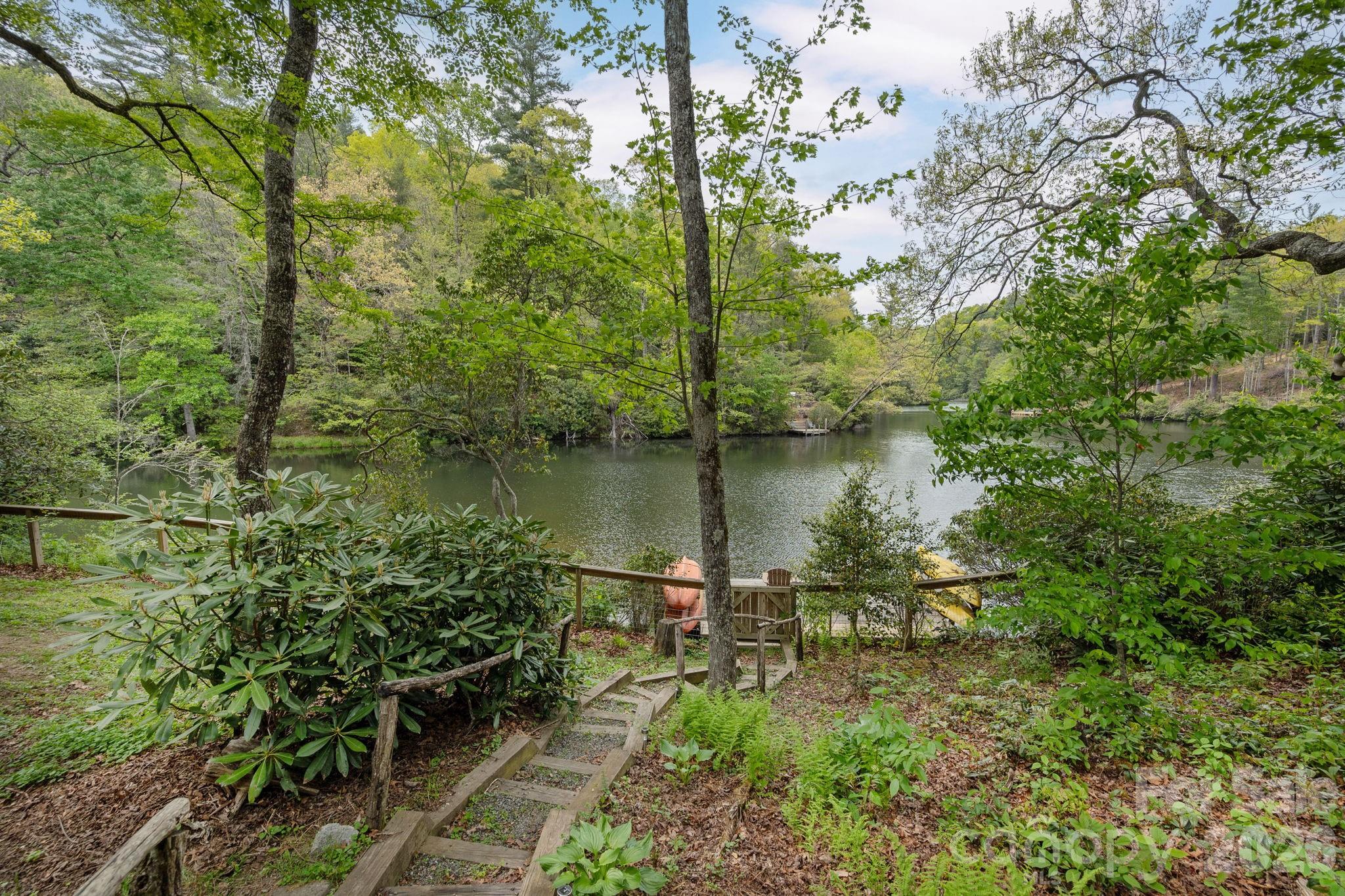 149 Hiwassee Road Lake Toxaway, NC 28747 - Photo 40 of 48 a view of a lake with a house in the background