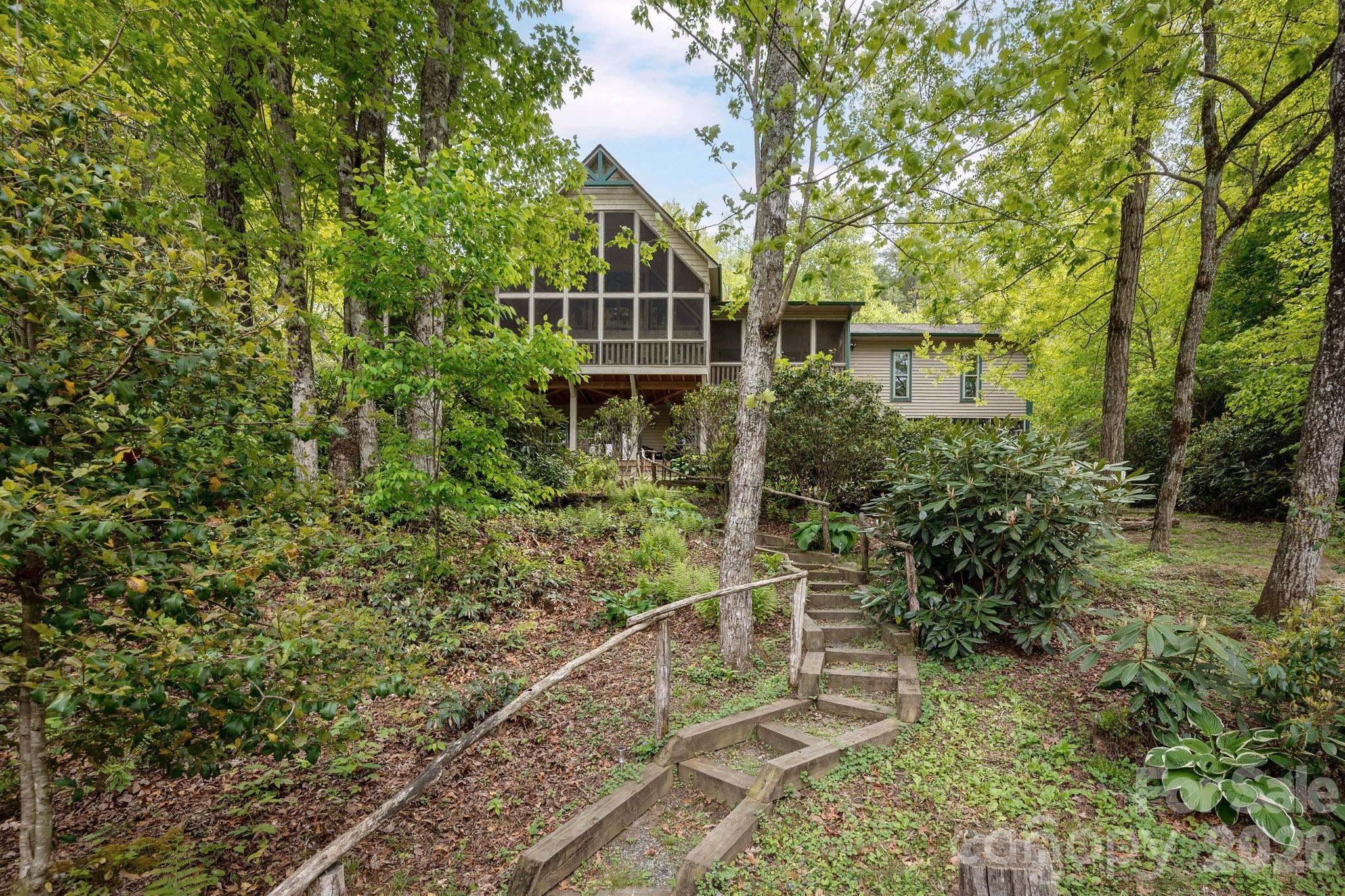 149 Hiwassee Road Lake Toxaway, NC 28747 - Photo 41 of 48 a house with trees in front of it