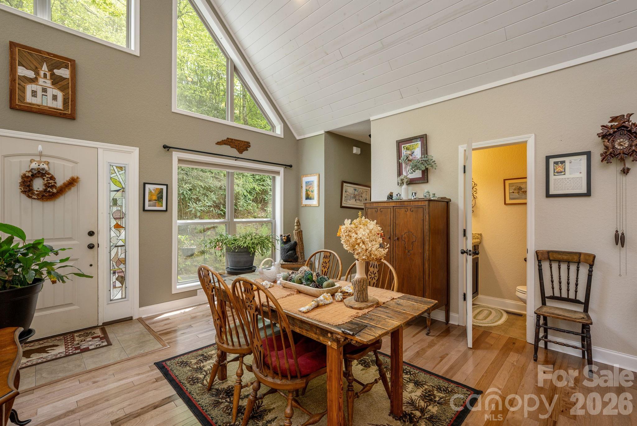 149 Hiwassee Road Lake Toxaway, NC 28747 - Photo 6 of 48 a view of a dining room with furniture window and wooden floor