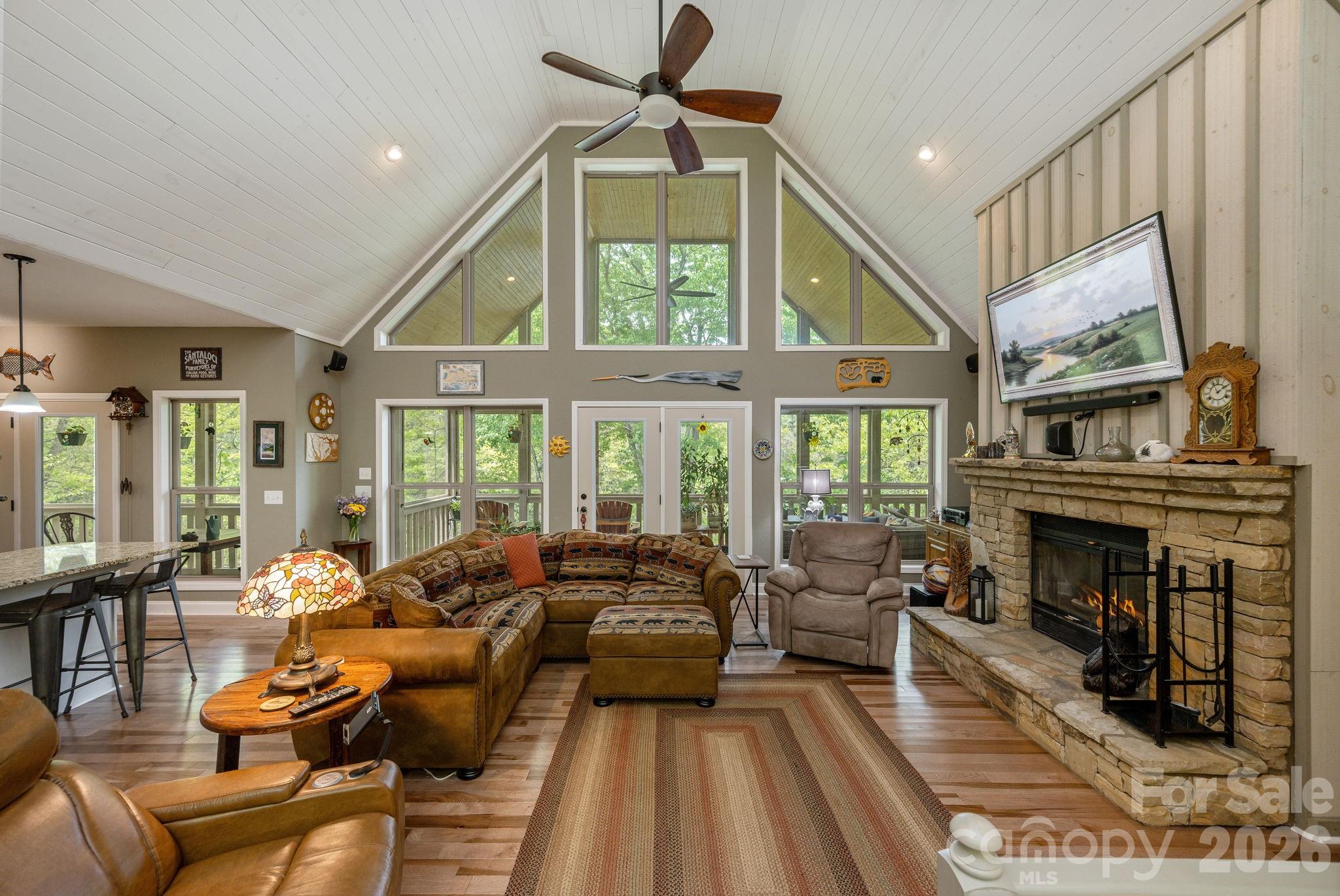 149 Hiwassee Road Lake Toxaway, NC 28747 - Photo 9 of 48 a living room with furniture a fireplace and a chandelier