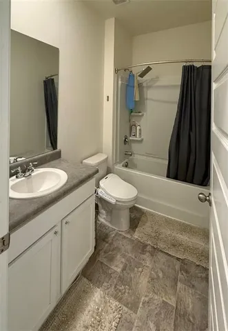 a bathroom with a double vanity sink toilet and shower