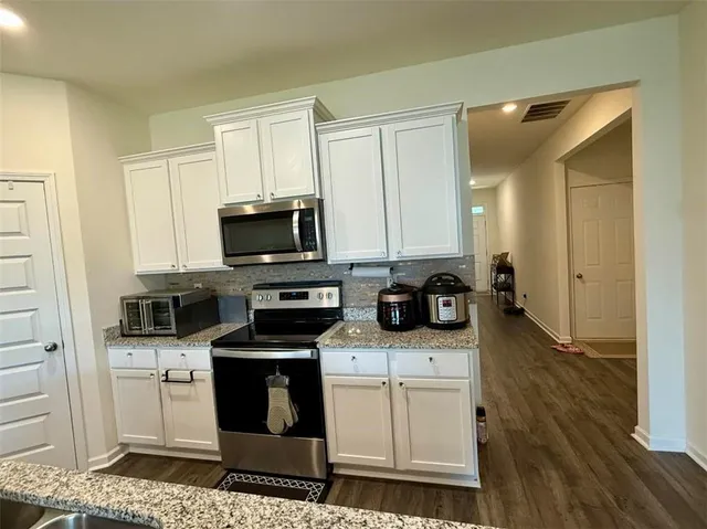 a kitchen with a sink stove and microwave