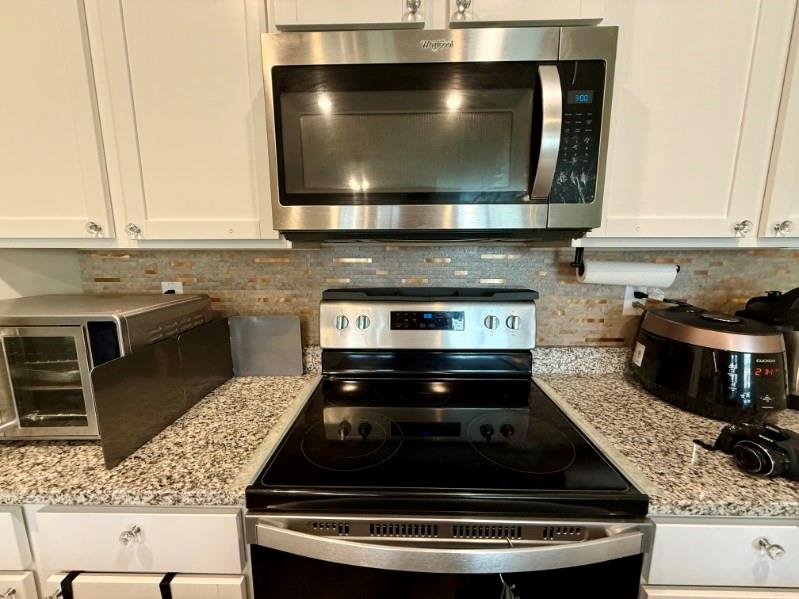 2015 Waycross Lane Dacula, GA 30019 - Photo 22 of 49 a kitchen with a stove and a microwave