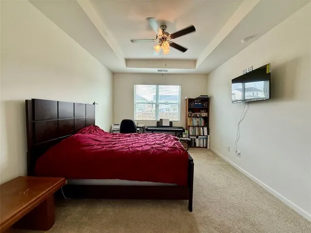 a bedroom with a bed and a tv