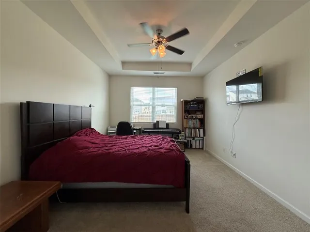 a bedroom with a bed and a tv