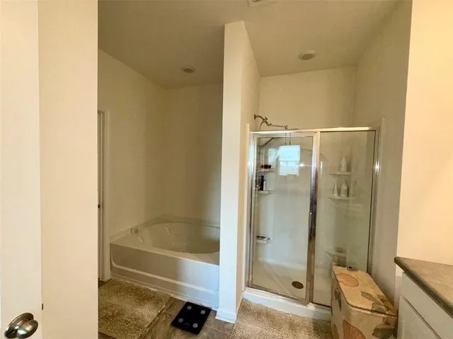 a bathroom with a bathtub and a shower