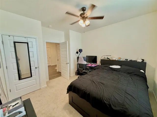 a bedroom with a bed and a chandelier