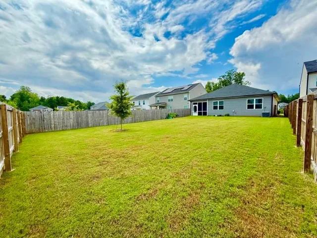 a view of an ocean with house in the background