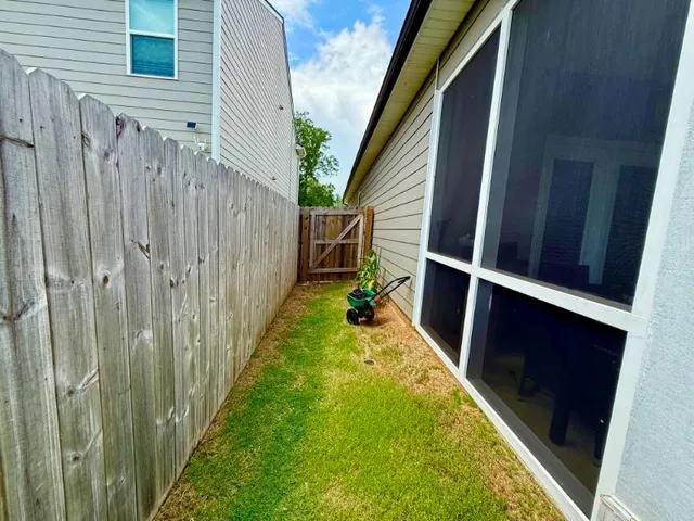 a view of a backyard with wooden fence and a staircase