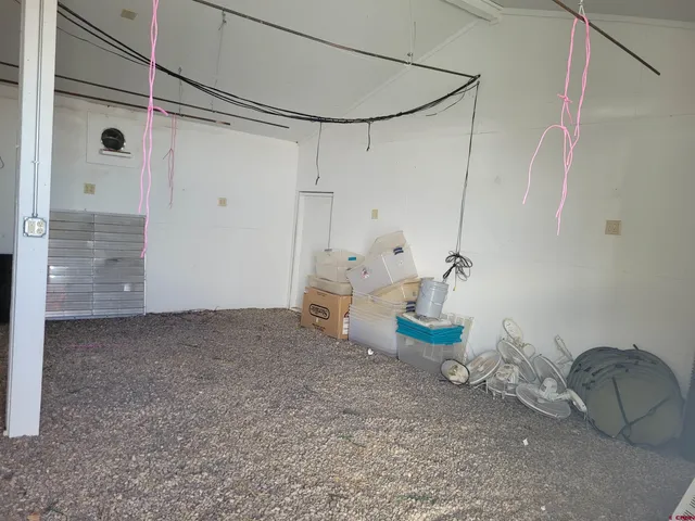 a room with a table chair and a wooden floor