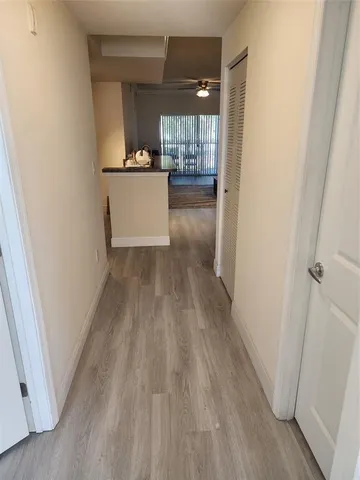 a view of workspace with wooden floor and windows