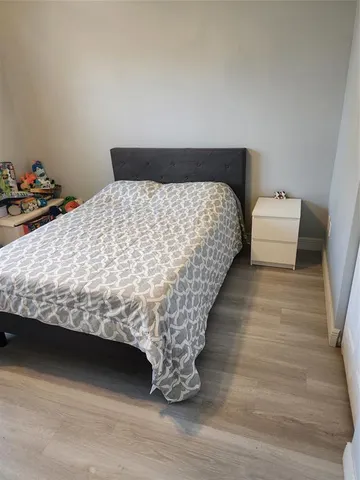 a bed sitting in a bedroom next to a cabinet