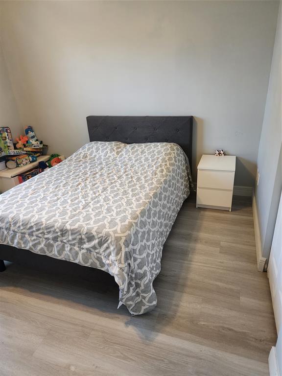 5880 West Sample Road, Unit 206 Coral Springs, FL 33067 - Photo 22 of 34 a bed sitting in a bedroom next to a window