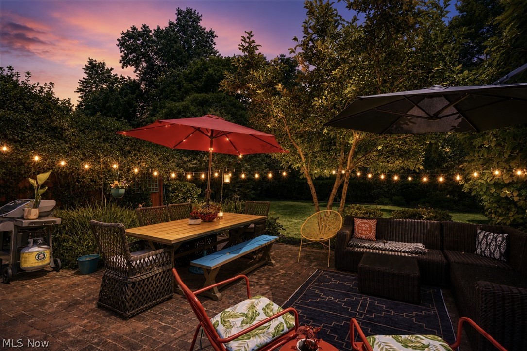 183 Overwood Road Akron, OH 44313 - Photo 5 of 34 Brick paver patio featuring string lighting, mature trees, and landscaping