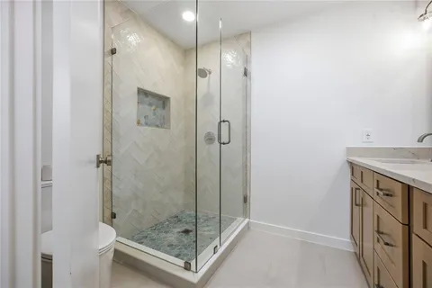 a bathroom with a shower and a sink
