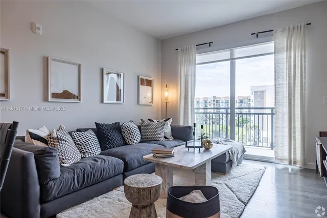 a living room with furniture and a large window