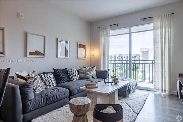 a living room with furniture and a large window