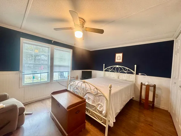 a bedroom with bed and window