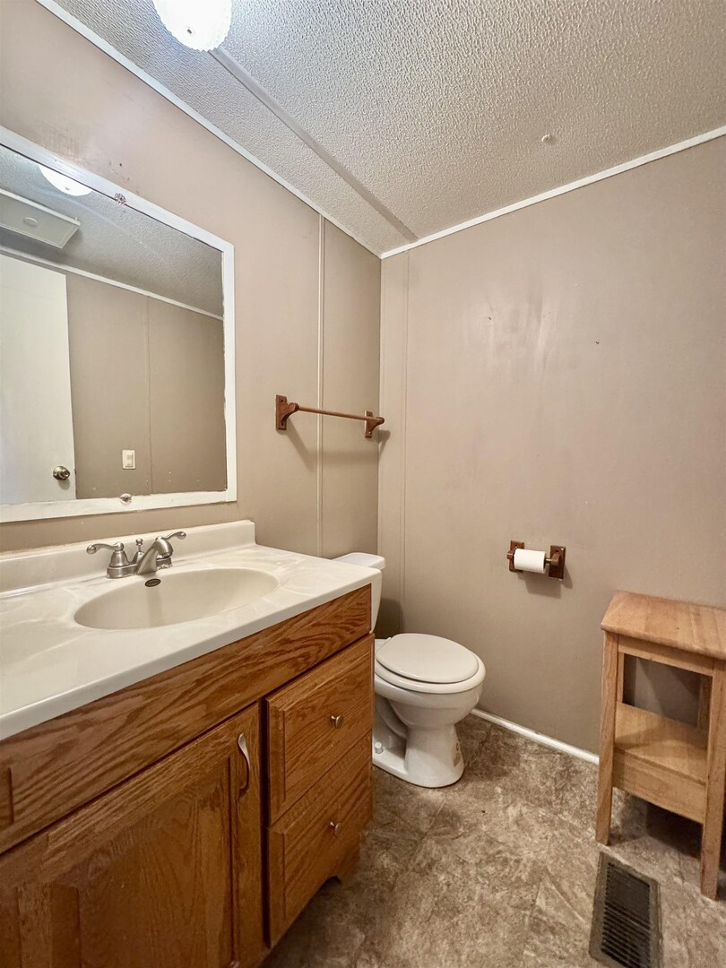 414 West Taylor Street Benton, IL 62812 - Photo 9 of 11 a bathroom with a sink a toilet and mirror