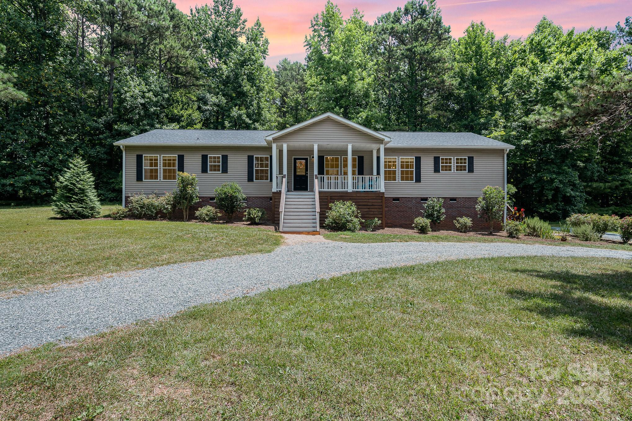 1403 Trinity Church Road Monroe, NC 28112 - Photo 1 of 28 a front view of a house with a yard and trees