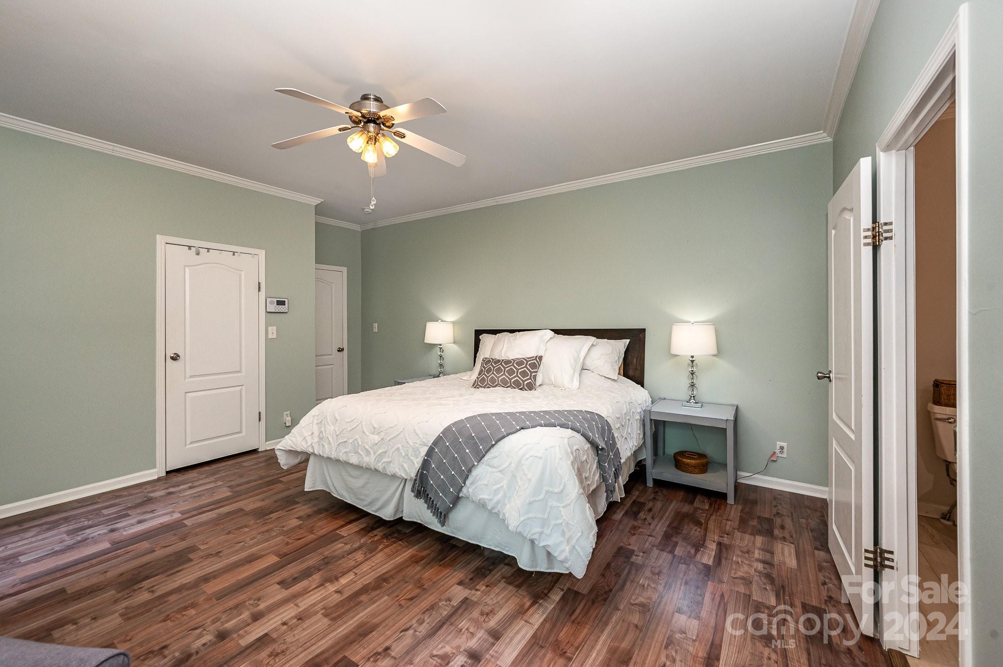 1403 Trinity Church Road Monroe, NC 28112 - Photo 18 of 28 a bedroom with a bed and wooden floor