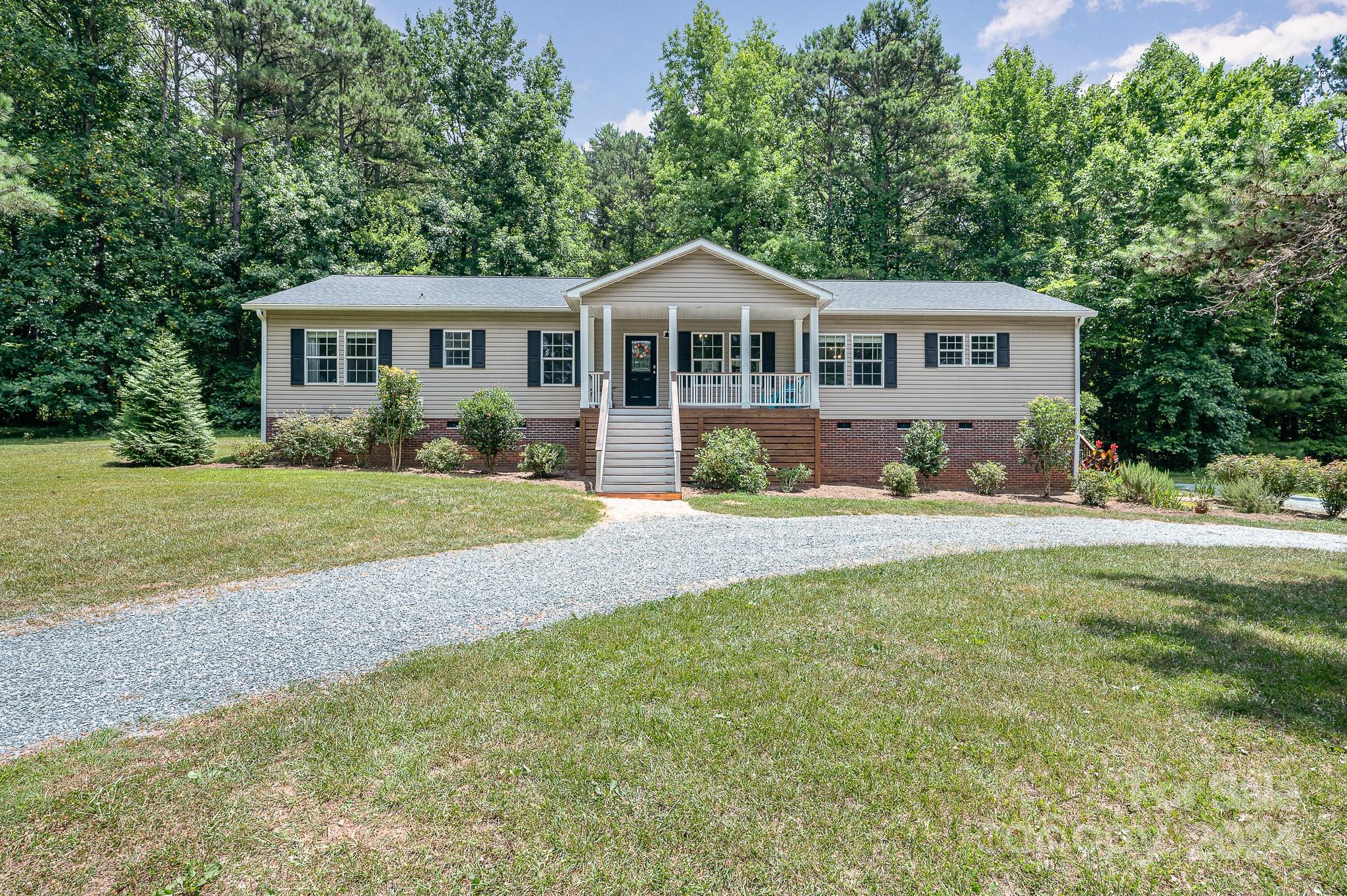 1403 Trinity Church Road Monroe, NC 28112 - Photo 3 of 28 a front view of a house with a garden