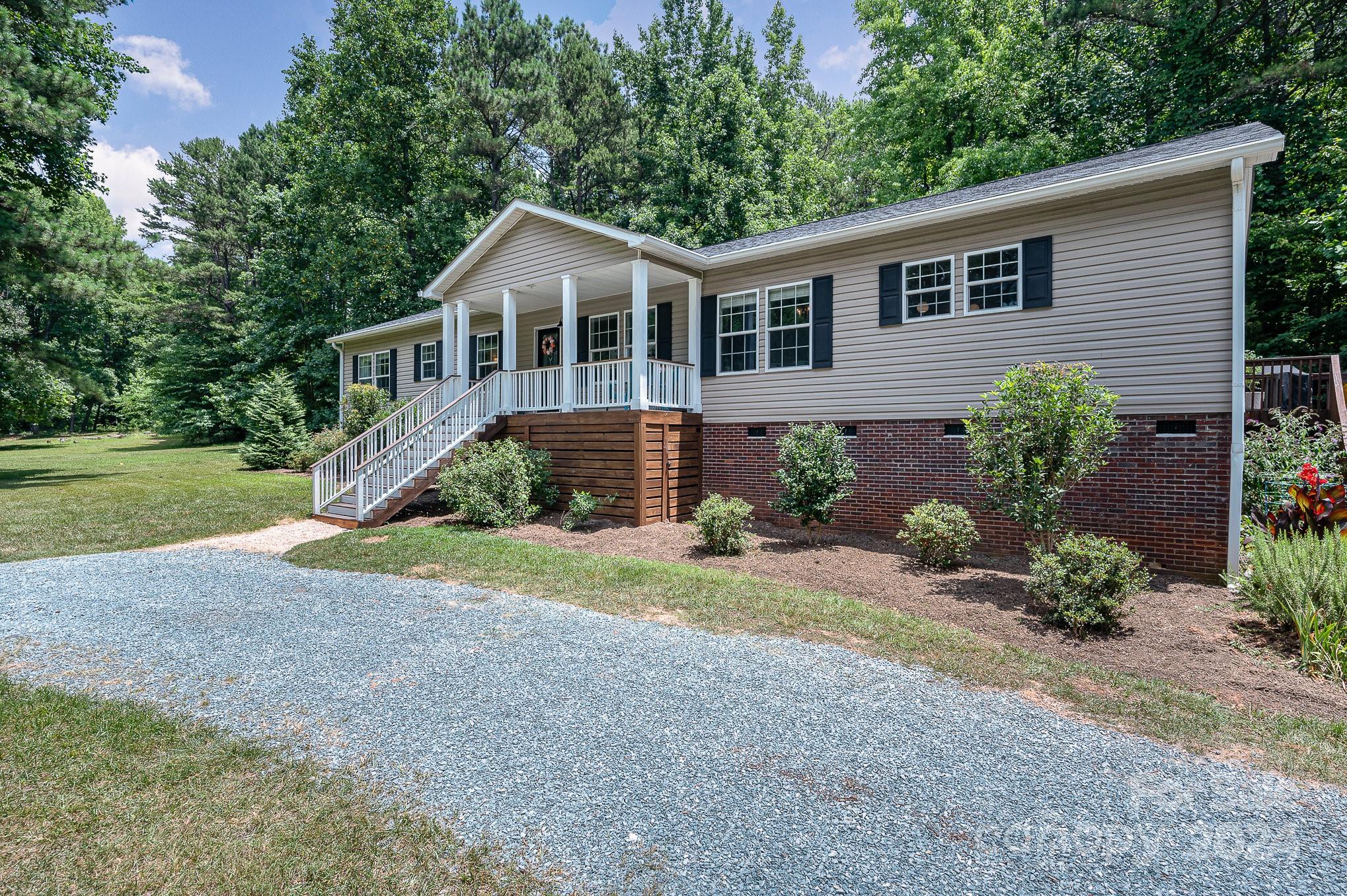 1403 Trinity Church Road Monroe, NC 28112 - Photo 4 of 28 a front view of a house with a yard and potted plants