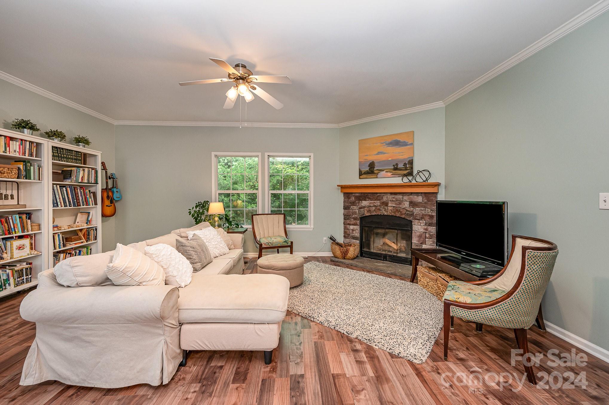 1403 Trinity Church Road Monroe, NC 28112 - Photo 6 of 28 a living room with furniture a fireplace and a flat screen tv