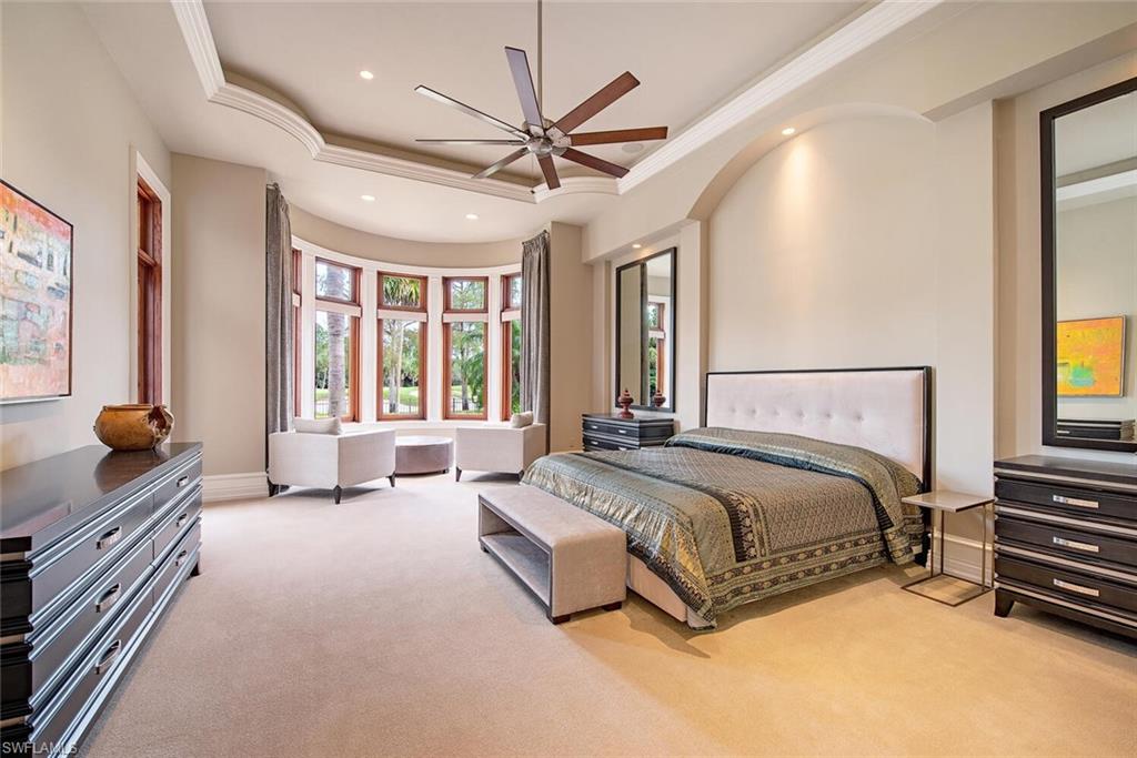 17016 Treviso Way Naples, FL 34110 - Photo 13 of 35 a spacious bedroom with a bed and a large window