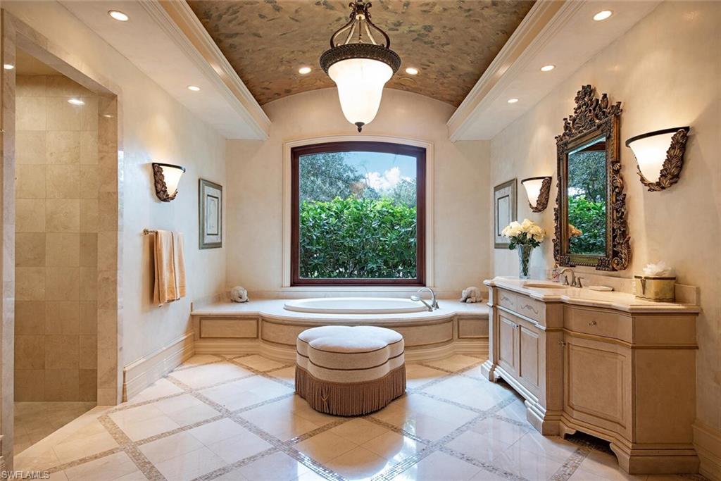 17016 Treviso Way Naples, FL 34110 - Photo 14 of 35 a bathroom with a bathtub sink and toilet