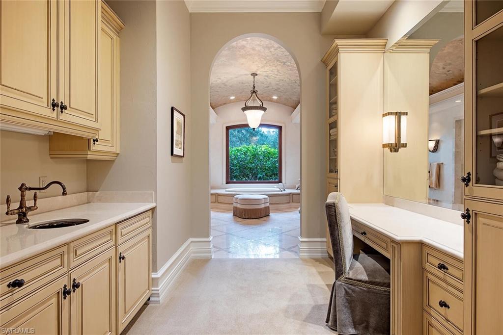 17016 Treviso Way Naples, FL 34110 - Photo 15 of 35 a bathroom with a sink a mirror and a bathtub