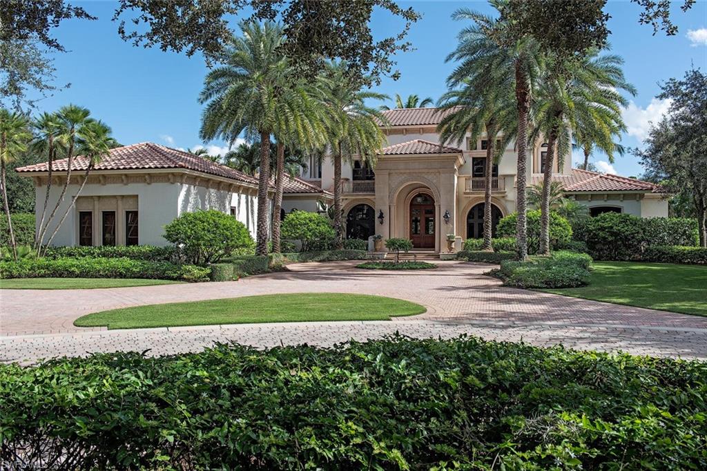 17016 Treviso Way Naples, FL 34110 - Photo 2 of 35 a front view of a house with a garden