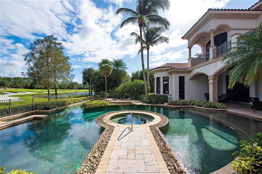 17016 Treviso Way Naples, FL 34110 - Photo 21 of 35 a view of a house with swimming pool and a small yard