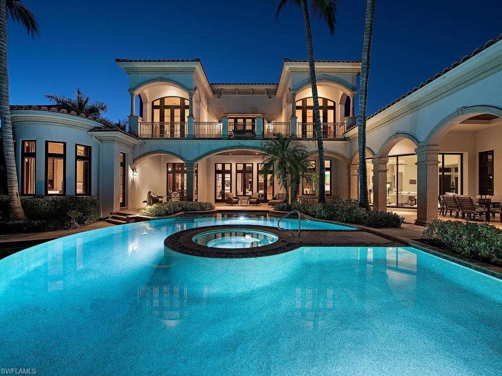 17016 Treviso Way Naples, FL 34110 - Photo 24 of 35 a front view of a house with swimming pool having outdoor seating