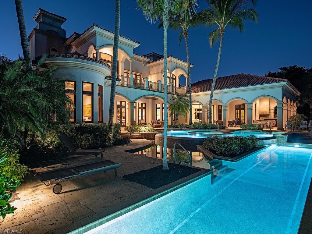 17016 Treviso Way Naples, FL 34110 - Photo 25 of 35 a front view of a house with garden and sitting area