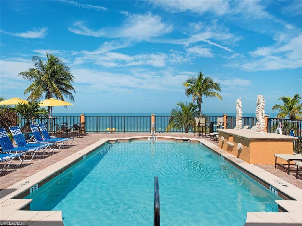 17016 Treviso Way Naples, FL 34110 - Photo 35 of 35 a swimming pool with outdoor seating and yard