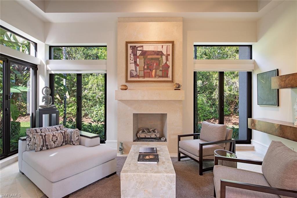 17016 Treviso Way Naples, FL 34110 - Photo 6 of 35 a living room with furniture and a fireplace