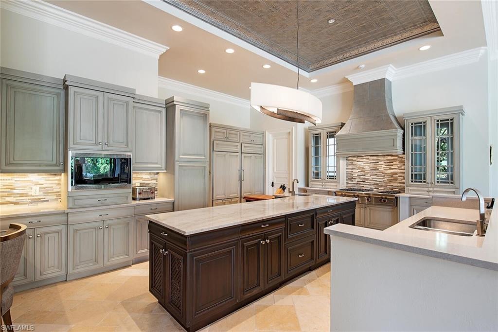 17016 Treviso Way Naples, FL 34110 - Photo 9 of 35 a kitchen with a sink stove and cabinets