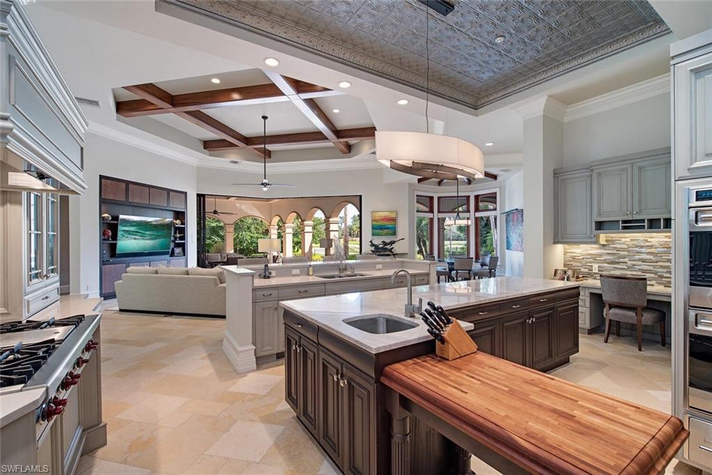 17016 Treviso Way Naples, FL 34110 - Photo 10 of 35 a kitchen with stainless steel appliances granite countertop a sink and stove