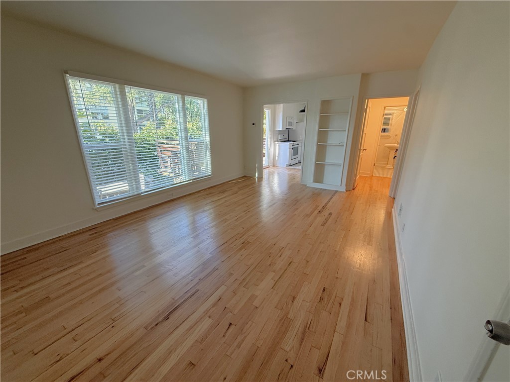 1007 9th Street, Unit 1 Santa Monica, CA 90403 - Photo 3 of 17 a view of a room with wooden floor and a window
