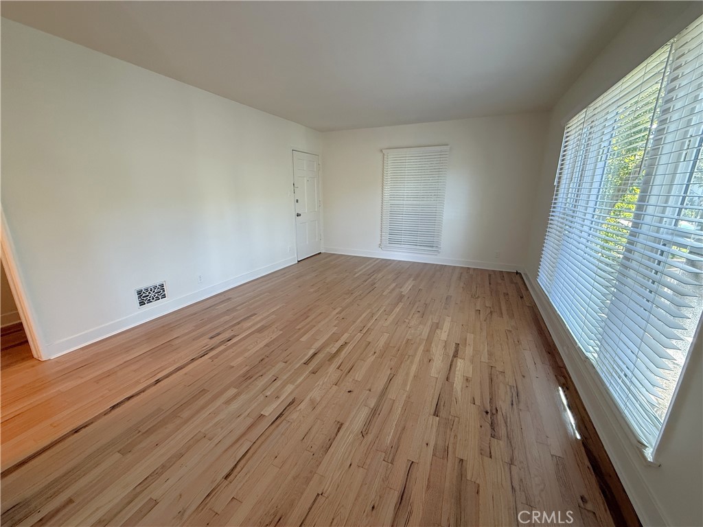 1007 9th Street, Unit 1 Santa Monica, CA 90403 - Photo 4 of 17 wooden floor in an empty room with a window