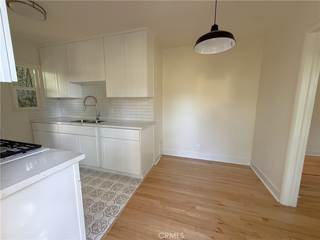 1007 9th Street, Unit 1 Santa Monica, CA 90403 - Photo 5 of 17 a kitchen with a sink stainless steel appliances a stove a refrigerator and cabinets