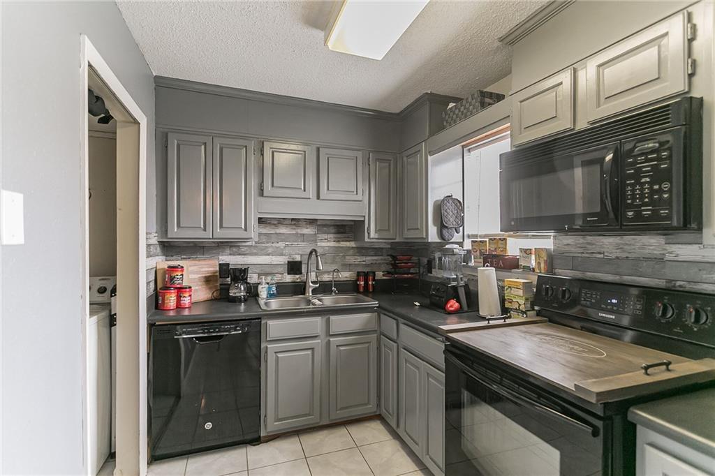 a kitchen with stainless steel appliances granite countertop a stove sink microwave and cabinets