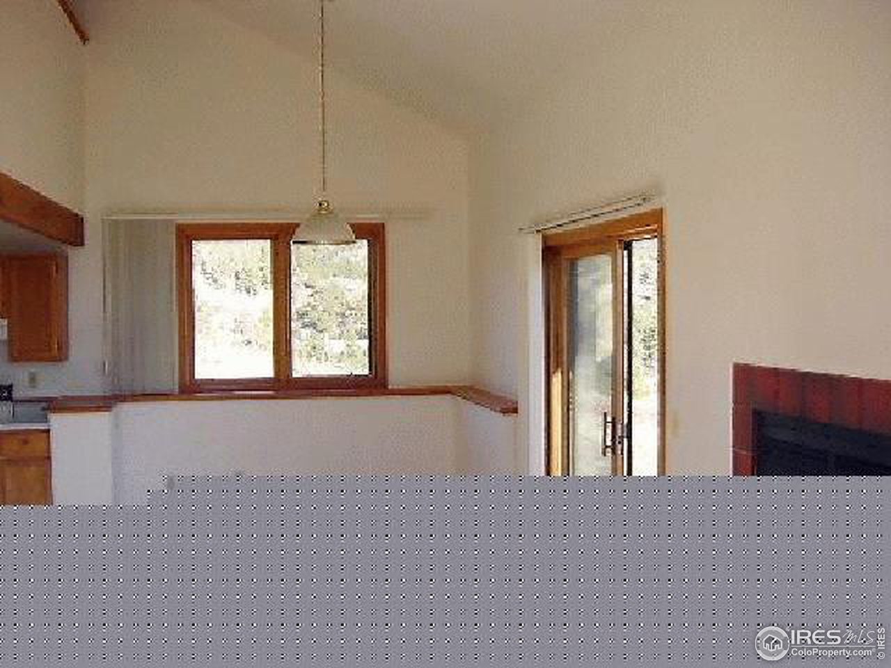 62 Chapman Road Boulder, CO 80302 - Photo 8 of 10 a view of an empty room with a window and a kitchen