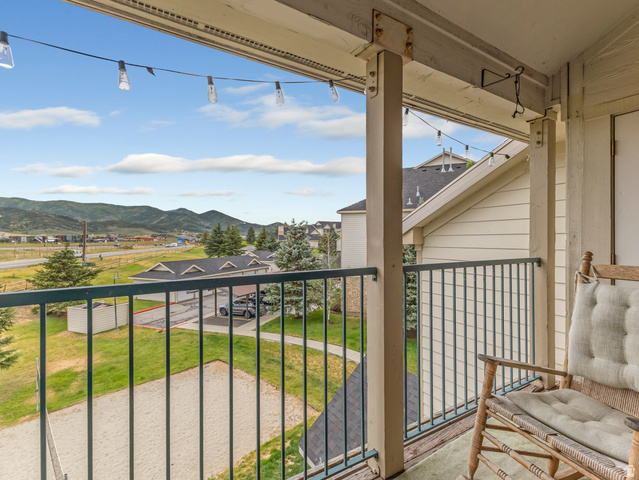 900 Bitner Road, Unit O33 Park City, UT 84098 - Photo 3 of 18 Exterior balcony featuring string lights, painted wood columns, and a dark metal railing