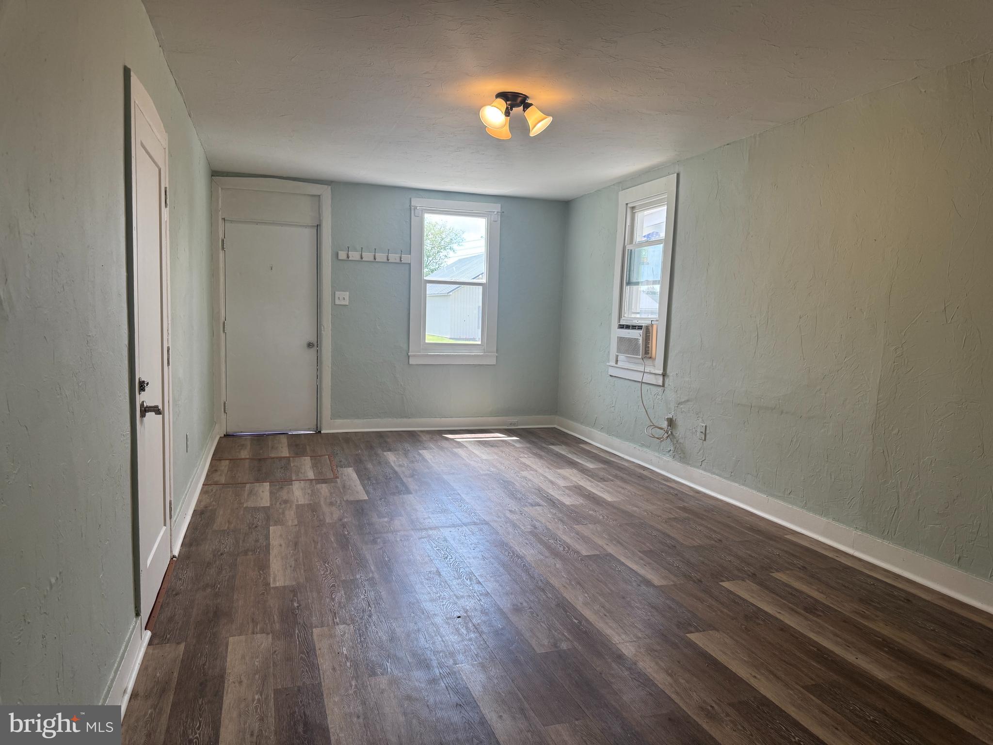 3754 Baltimore Pike, Unit 3 Littlestown, PA 17340 - Photo 5 of 21 an empty room with wooden floor and windows