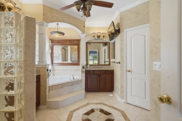 a spacious bathroom with a granite countertop sink mirror and bathtub